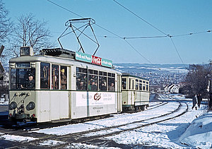 Triebwagen 13 der Herkulesbahn fährt über verschneite Gleise bergauf zur Dönche